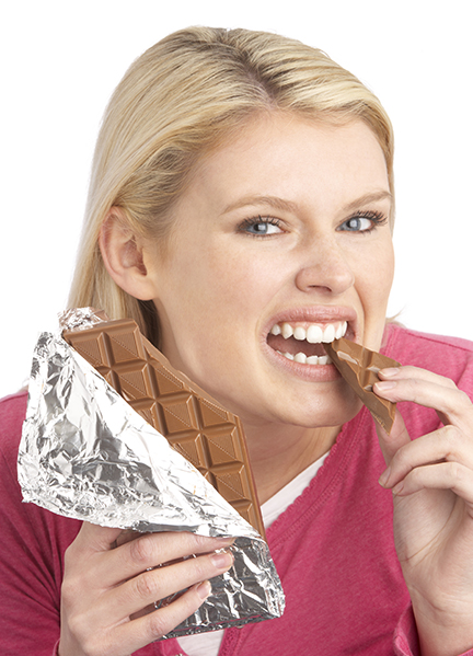 Young woman eating a chocolate bar