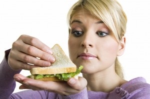 young blond Woman with healthy sandwich