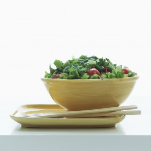 bowl of salad with tongs