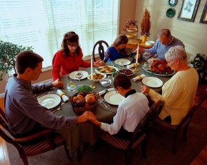 family praying at holiday dinner