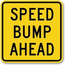 speed bump ahead sign