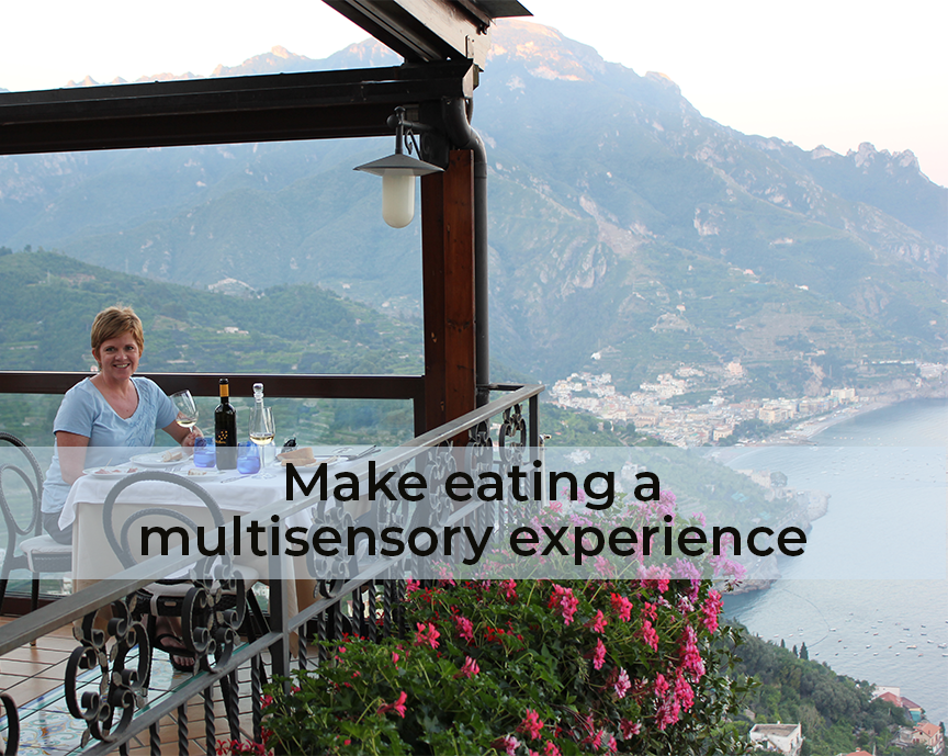 Michelle dining at a table overlooking the Amalfi Coast